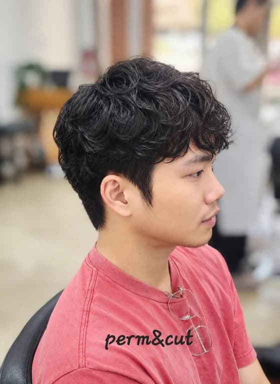Defined curls with a fresh cut, showcasing a stylish perm.